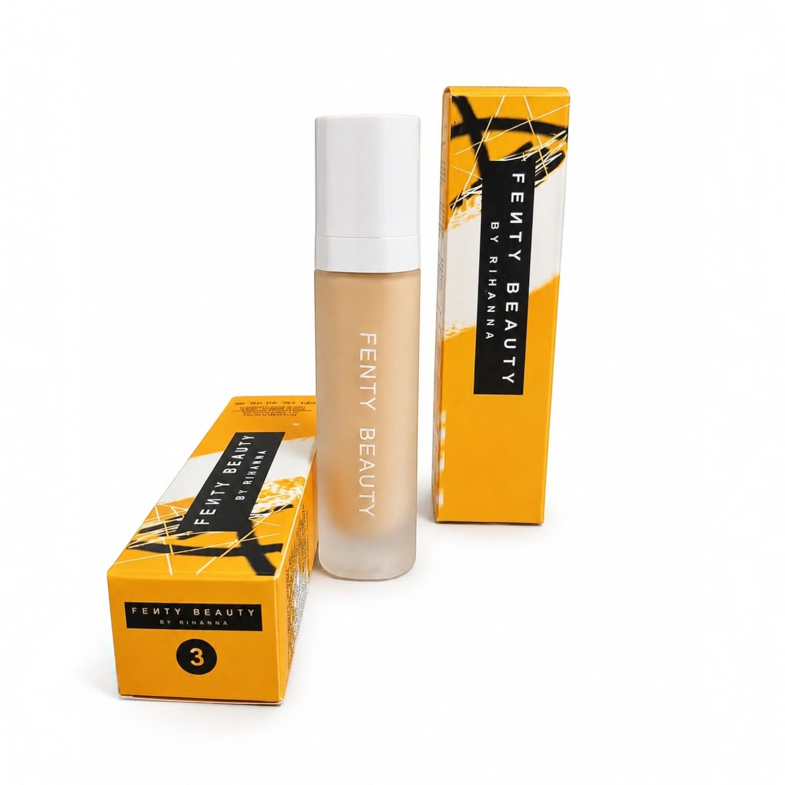 Marom FENTY BEAUTY by RIHANNA liquid foundation bottle with yellow and black packaging boxes on a white background.