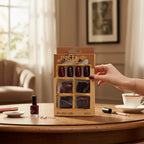 Marom INSTA PROFESSIONAL 96-piece dark red press-on nail set in packaging on a wooden table with a tea cup.