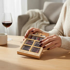 Marom INSTA PROFESSIONAL 96-piece press-on nail set in deep burgundy shades held by a woman in a cozy setting.