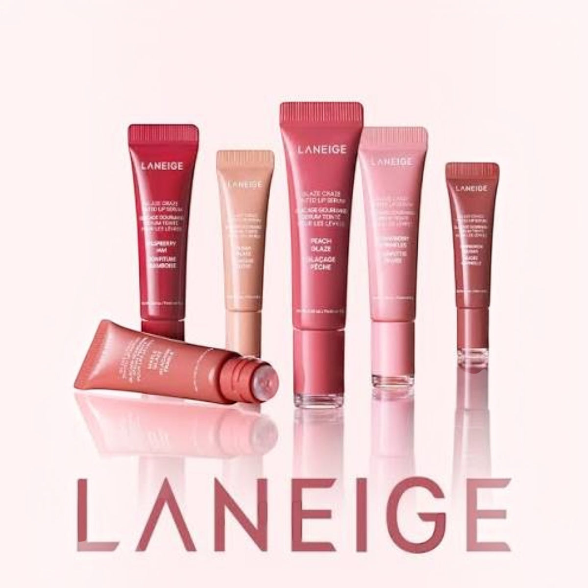 Marom collection of LANEIGE Glaze Craze Tinted Lip Serum tubes in various pink and nude shades on a reflective surface