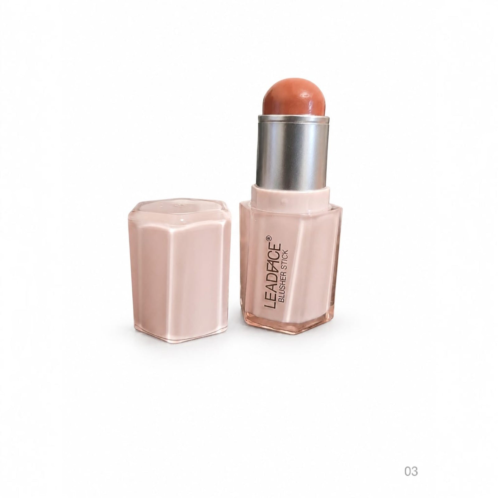 Marom Leadface blusher stick in a warm peach shade with a pale pink hexagonal case and cap on a white background