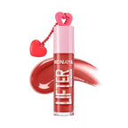 Marom Monaya high-shine lip gloss in a warm coral shade with a heart-shaped charm on the cap
