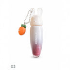 Marom Olibolla glossy lip tint in a white and pink gradient tube with a cute rabbit cap and carrot charm