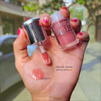 Marom Olibolla Glossy Lip Tint in shade 03, a sheer pink liquid formula with a shiny finish shown on a hand.