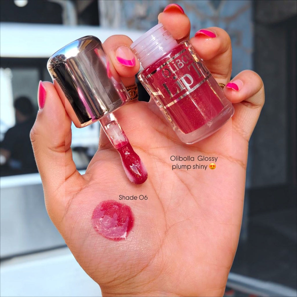 Marom Olibolla Glossy Lip Tint in shade 06, a vibrant berry pink liquid with a high-shine finish on a hand swatch.