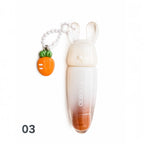 Marom Olibolla glossy lip tint in a white rabbit-shaped container with a cute carrot charm on a white background