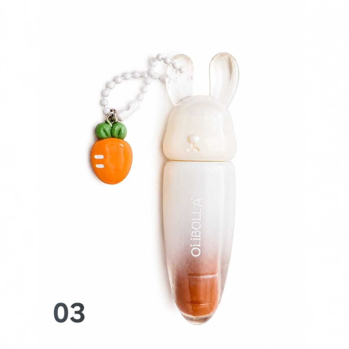 Marom Olibolla glossy lip tint in a white rabbit-shaped container with a cute carrot charm on a white background