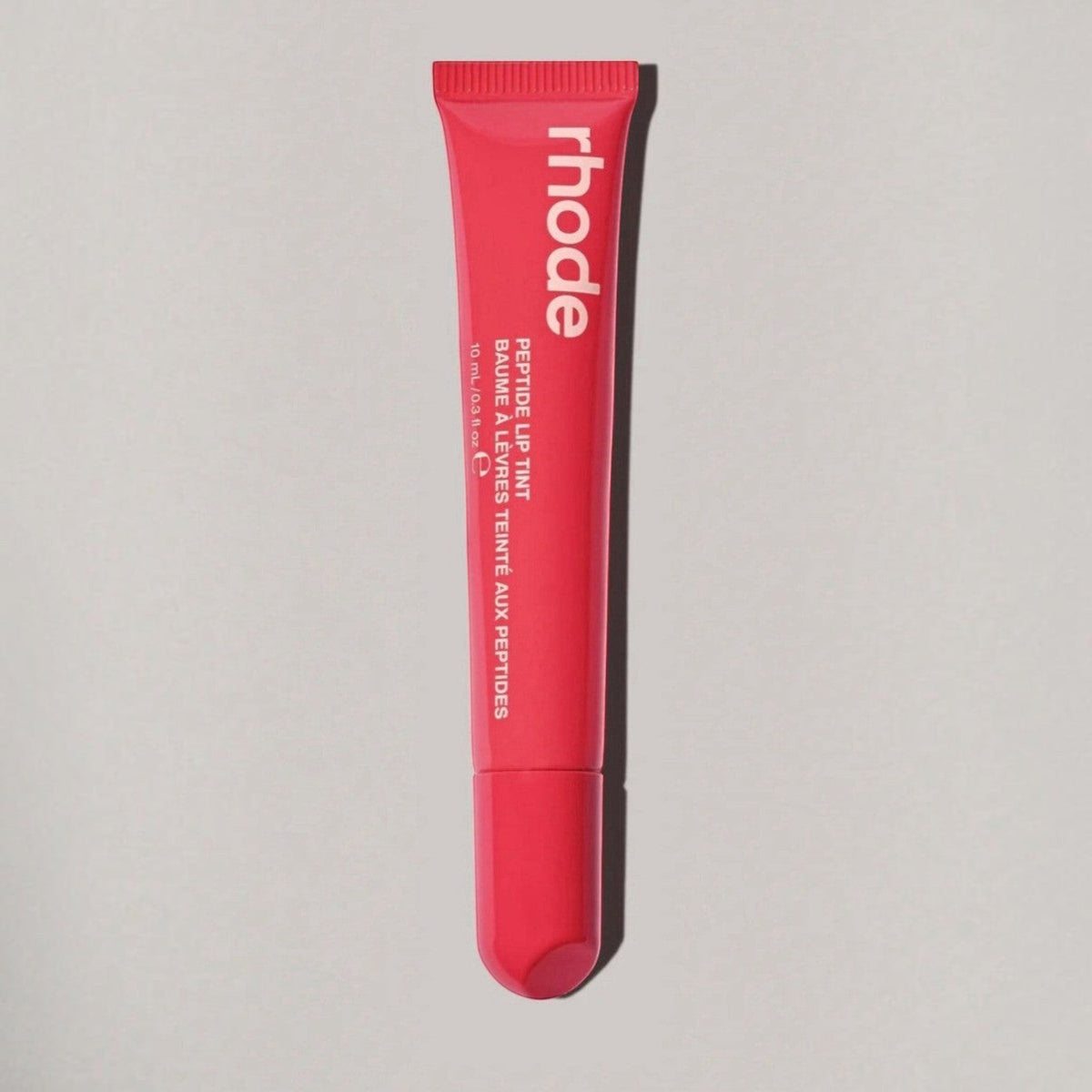 Marom rhode Peptide Lip Tint in a vibrant pink squeeze tube for hydrating and nourishing lip care.