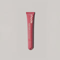 Marom rhode Peptide Lip Tint in a pink squeeze tube for hydrating and nourishing lips with a sheer glossy finish.