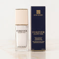 Marom Rose Berry Forever Glow Veil hydrating radiant primer bottle and dark blue packaging box on a marble surface.