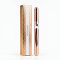 Marom RoseBerry ultra black eyeliner pencil in a metallic rose-gold casing next to its matching decorative box.