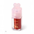 Marom Ruby Rose hydrating lip oil in a deep red shade with a clear bottle and a cute pink heart-shaped cap.